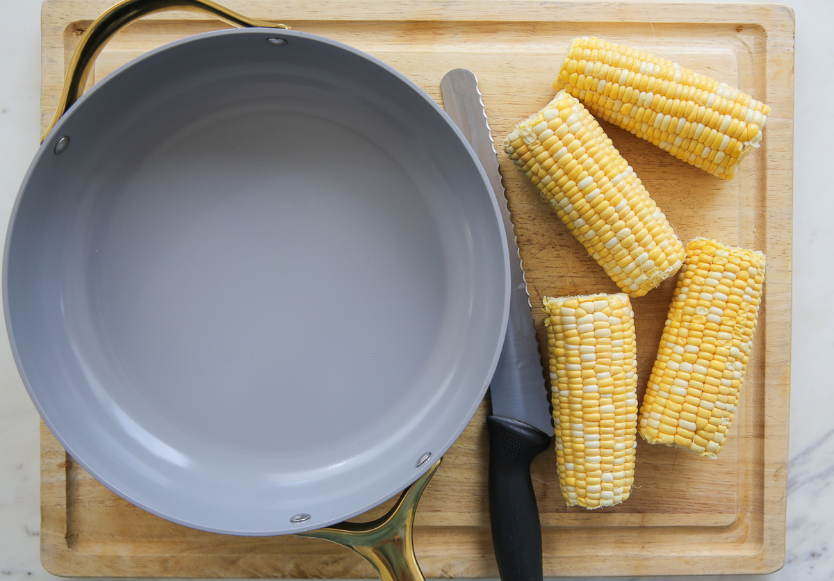 Pot next to fresh corn on the cob