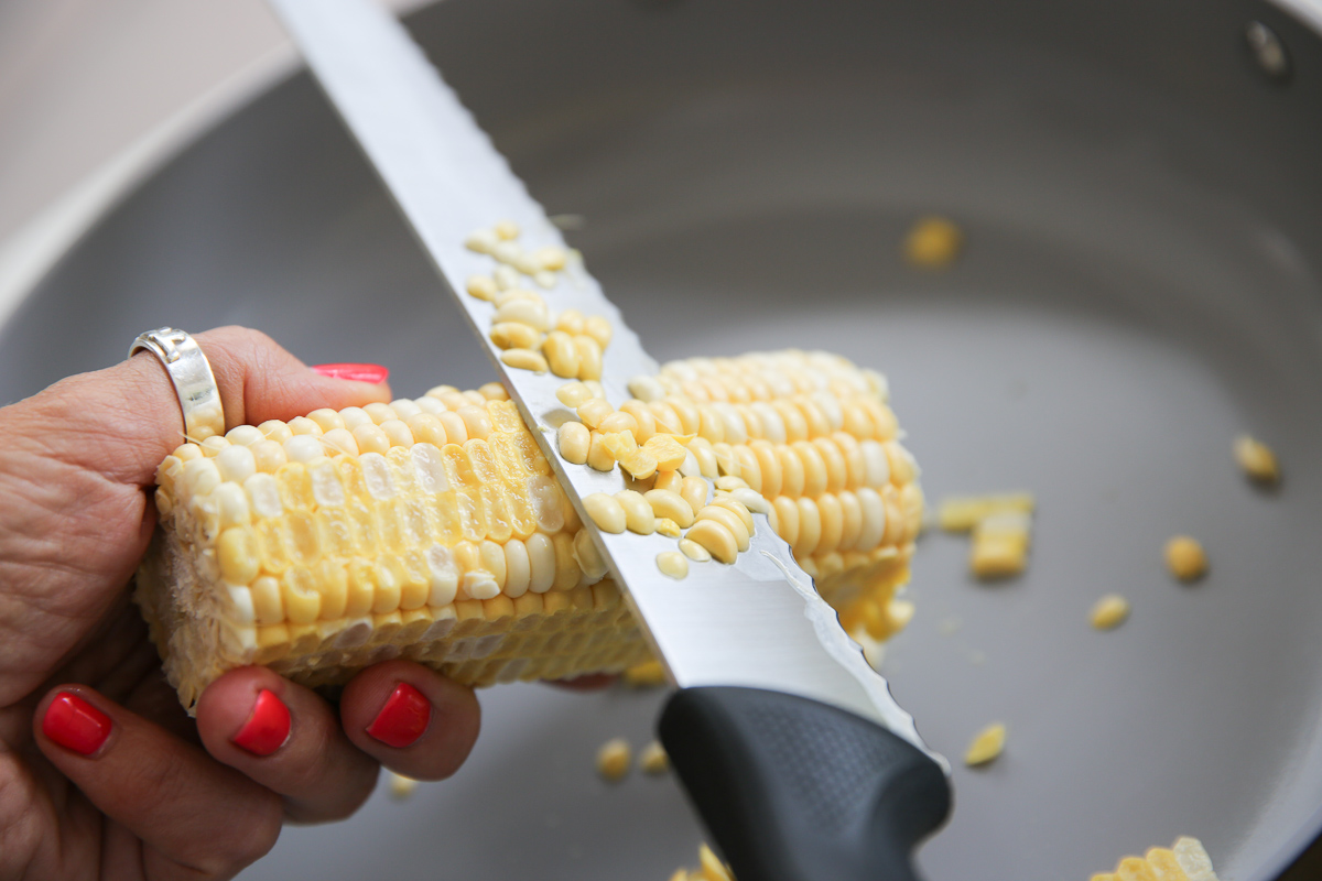 slicing tips off of fresh corn cob